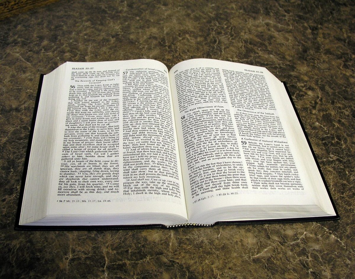 A Bible lying open on a dark surface